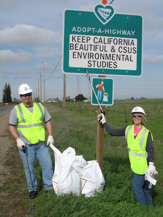 Two volunteers cleaning a roadside for Keep California Beautiful